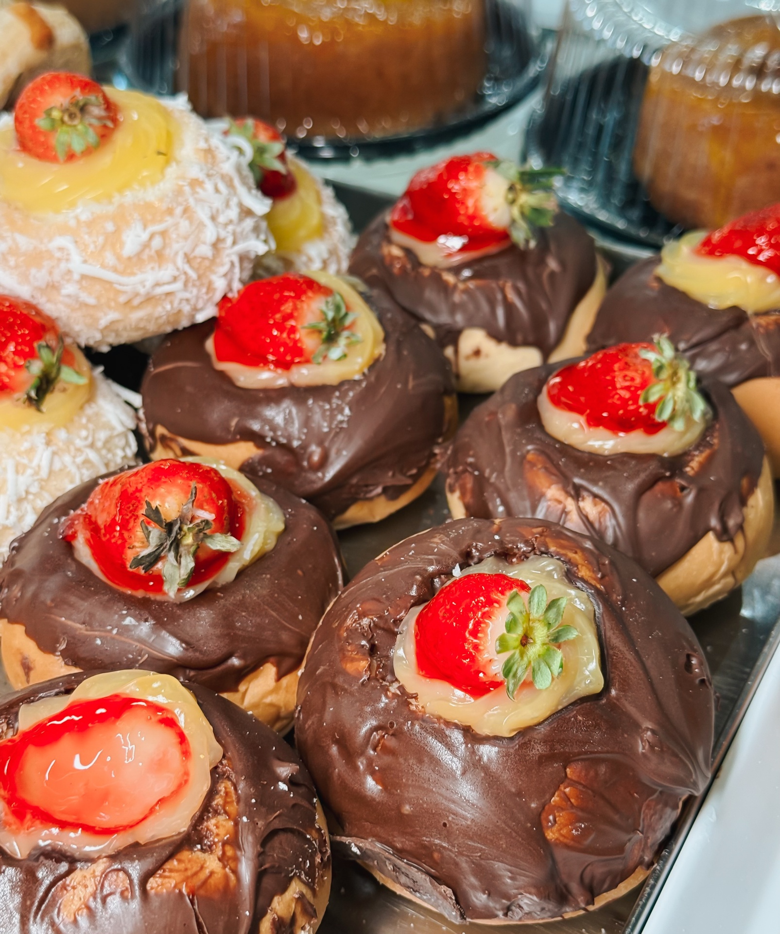 Sonhos cobertos com chocolate e morango